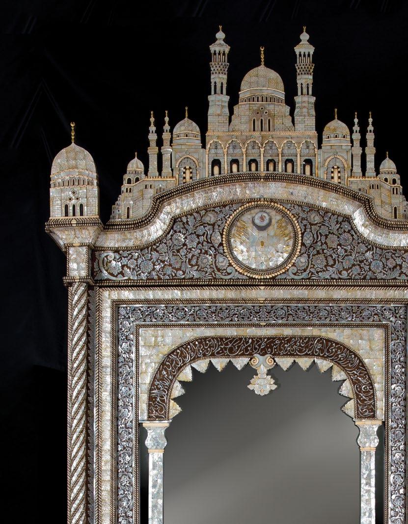 The cabinet is surmounted by a mosque shaped pediment of inlaid and carved mother-of-pearl, the arches and windows articulated with ivory inlay and hanging brass mosque lamps (later additions), the