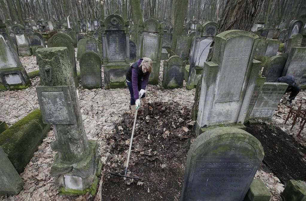 A volunteer helps to clean a Jewish cemetery in Warsaw, Poland, on Sunday April 14, 2013. AP Photo/Czarek Sokolowski I ask myself, why do I do it? Must I clean up other people s conscience?