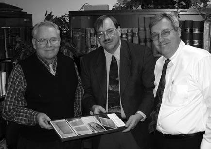 Ray L. Huntington (left) and Brian M. Hauglid (right) visit with Ronald E.