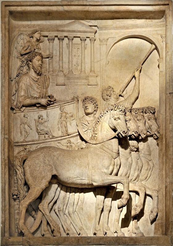 Marcus Aurelius in his triumph, ca. 176-180 from a lost arch of M. A. in Rome. M. A. stands in his triumphal chariot. Someone is missing.