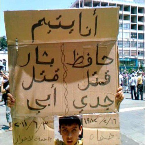 Graffiti / Posters Photograph from an early protest, of a boy holding up a