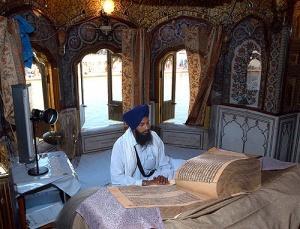 Sikhism Holy Book The Guru Granth Sahib is kept on a raised platform under a canopy in the place of worship.