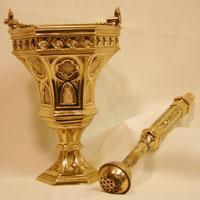 The Aspergillum is the long tube shaped item that holds the holy water to sprinkle the faithful or articles