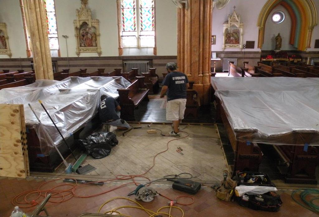the cutting of pews, preparation of floor to receive porcelain tile and