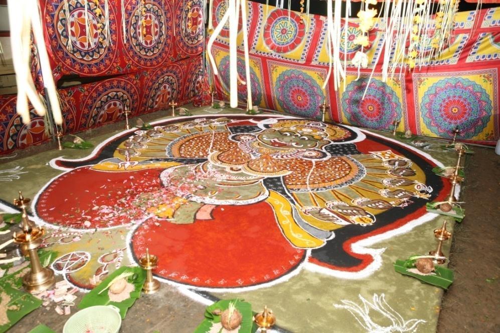In Kalamezhuthu, The figure of Bhadrakaali is drawn with five colours, red, green, black, white and yellow derived from indigenous materials - rice, turmeric,