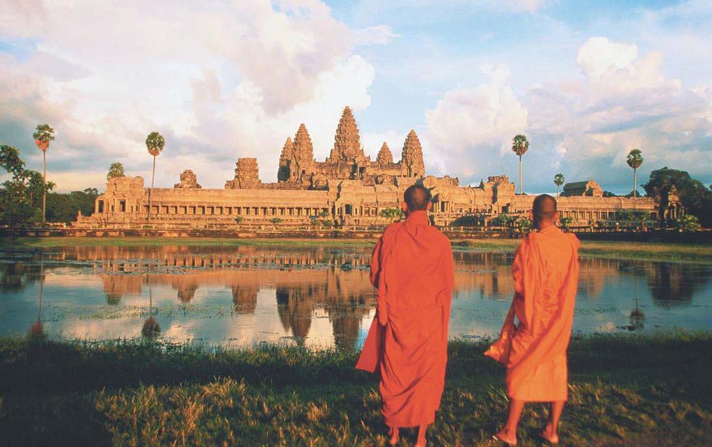Buddhist monks view a temple at Angkor Wat in Cambodia. Reading Check Compare In what ways are Buddhism and Hinduism similar?