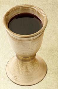 A PASSOVER SEDER Cup of Elijah Leader holds up the cup from