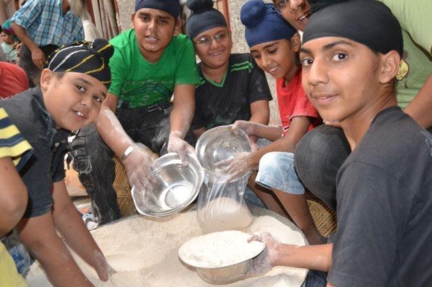 A young Sikh Girl volunteering at the Langar (Community Kitchen) in the Gurdwara
