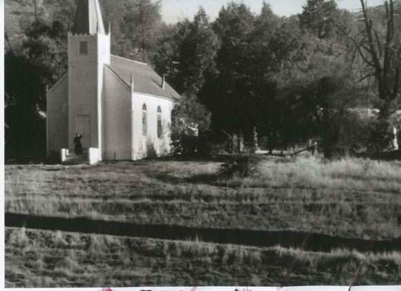 Photograph 6: View of the church in the circa 1920s with the wooden stairs and hog fencing surrounding it. Note the lack of any formidable landscaping.