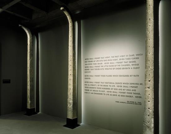 Auschwitz fence posts encompass a quotation from Elie Wiesel's book Night in the third floor tower room of the permanent exhibition at the