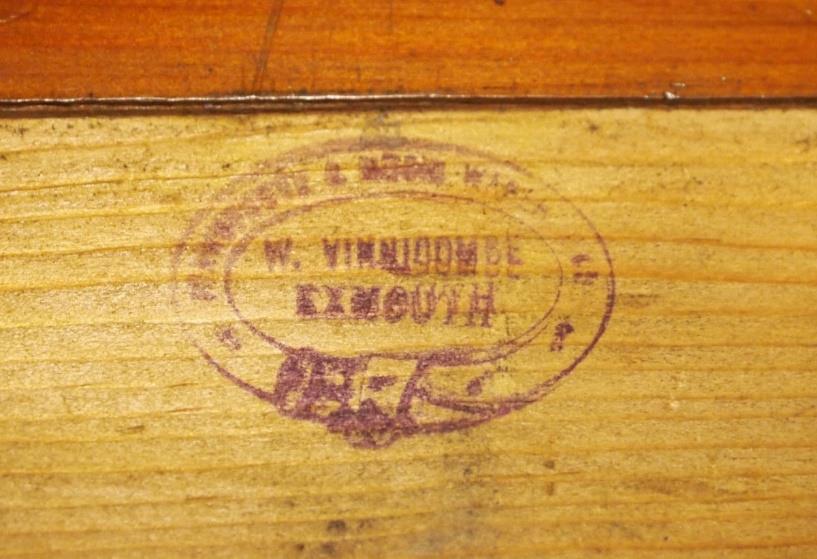 The trade stamp of Vinnicombe's Music Shop, Exmouth, on the back of the nameboard. Underneath the stylish marquetry of the two birds is scratched the number 1664.