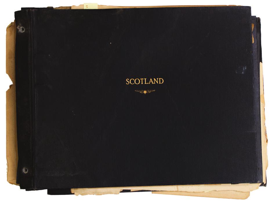 QUESTION 1 OF 11 This is a photo album that contains pictures of Scotland from the 1920s. There are photos of lakes, mountains, and other landscapes. There are also pictures of men dressed in kilts.