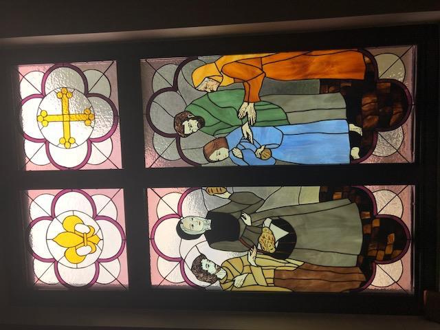 The fifth window represents Feed the Hungry. Our patroness emulated all the Corporal Works of Mercy.