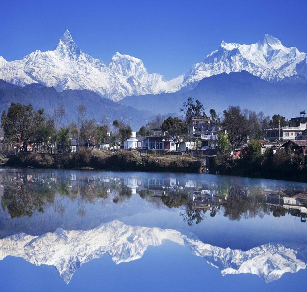 Pokhara, set in a lush topical alley, with a backdrop of the Annapurna range,