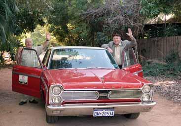 Pat Walton (left) and Bishop Christopher Saunders alongside their 1966 Dodge Phoenix which cruised it home in the