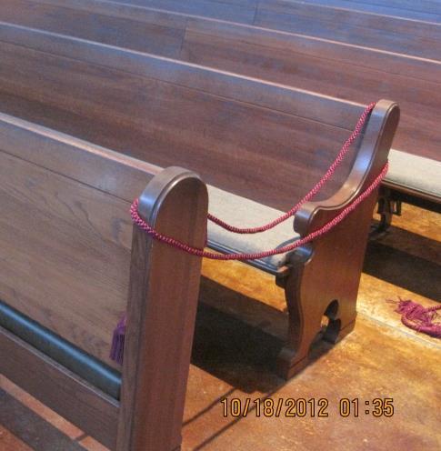 The Lead EMHC will sit near the end of the first pew on the AMBO/ Lectern (St. Mark Pillar) side of the Church.