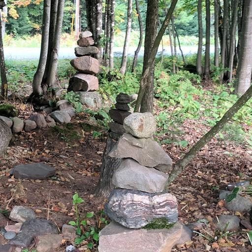 Years of dirt had covered these piles of rocks, offering enough top soil for daisies, ferns, and golden rod to grow, but not enough to pack down the earth and offer stable footing.