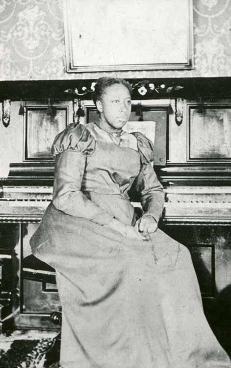 Mabel Webb Van Dyke was the youngest child of Frederick and Lucina Barton Webb. She is shown here as a young woman in the parlor of her home.