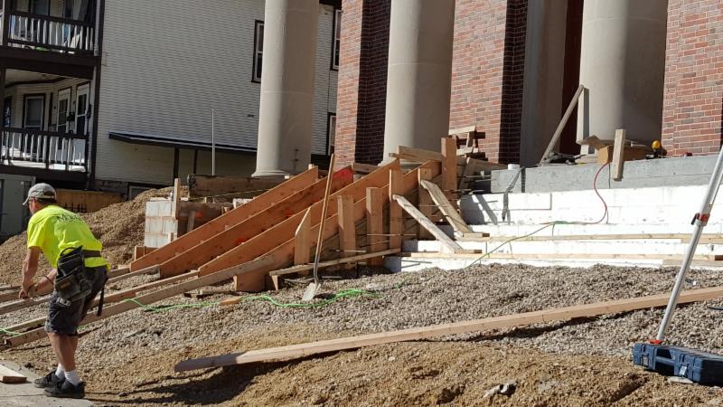 Progress continues on the remake of the front steps! The crumbling front steps are being removed and replaced, and new handrails installed.