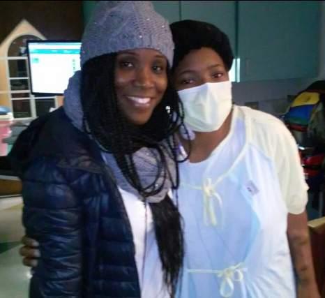 Nadirah Muhammad and A ja Booth embrace three days after operation. A mask was worn because A ja s immune system was still low.