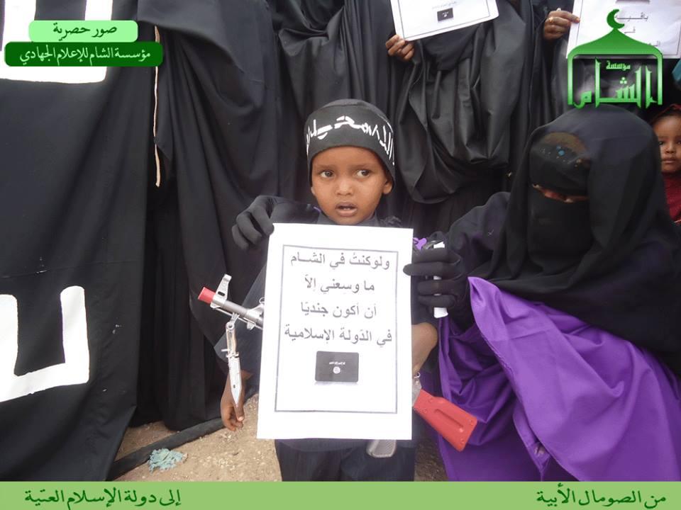 A Somali child holds the same placard