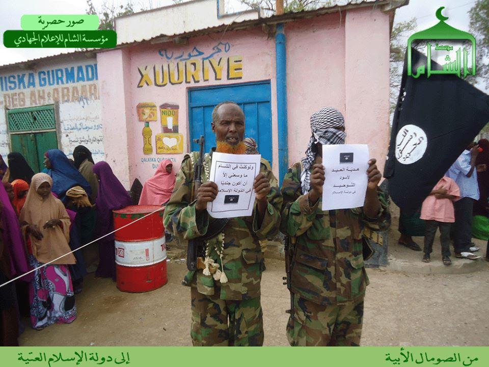 Two HSM fighters show their support for ISIS. The mujahid on the left displays the same placard as in the first photo from this series.