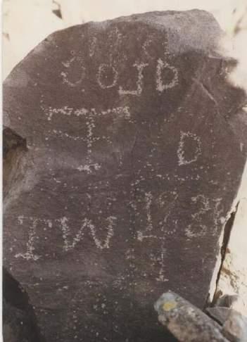 The rock with the cross has been interpreted as having the initials AW and LD, or AW and UJ, or AW and LB, with a dot or a dash between them (Palmer 1941; Kelly 1950:12; Knipmeyer 2002; Utah State