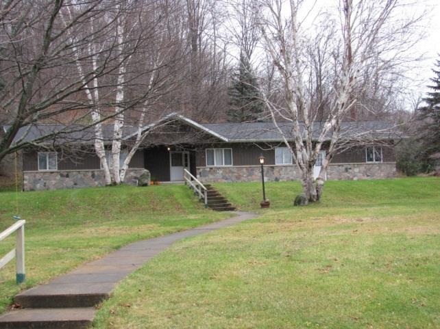 The location of the building tucked against the hillside, conceals the size of the interior. The kitchen cabinets were especially made by Everett Wescott.