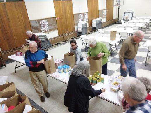 Faith Works Fellowship (Fellowship members packing 30 bags of Thanksgiving meals.