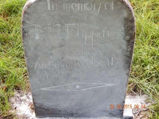 Back of stone reads: Here