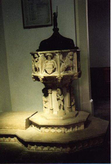 The Nave The Font c 1400 This is a typical East Anglian design with octagonal panelled bowl carved with lions interspersed with angels holding shields on which are displayed the instruments of the