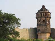 Watch tower and broken wall of the fort city Hampi interlocking. Many foreign travellers visited Vijayanagar Empire in the sixteenth century.