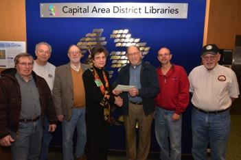DIVISION 5 DONATES TO LANSING LIBRARY Photo Caption: Kathy Johnson, Head Librarian, receives check from Division 5 Superintendent Andy Keeney. Pictured from left Mark Frechette, Asst.