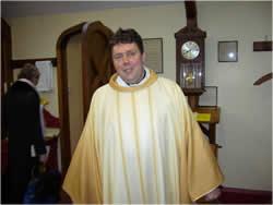 Now everything is ready for mass to start. Father Atli is now wearing his vestments. He wears these special clothes when he says mass. The entrance procession is led by the cross.