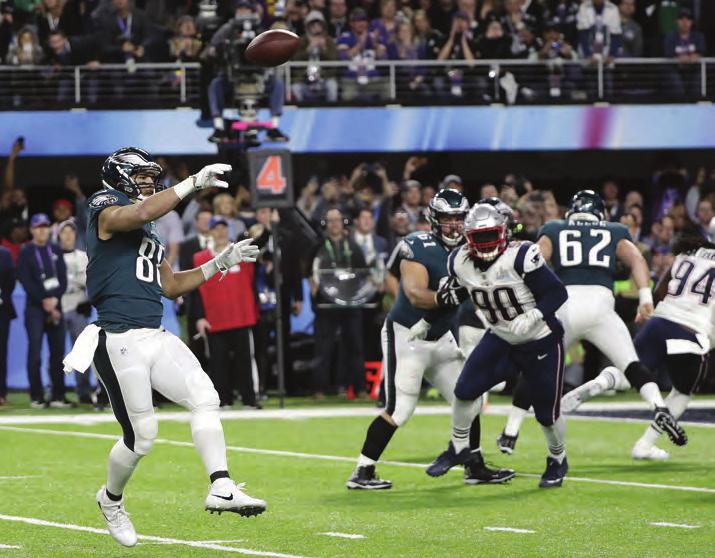 Trey Burton, left, throws a touchdown pass to Nick Foles during the