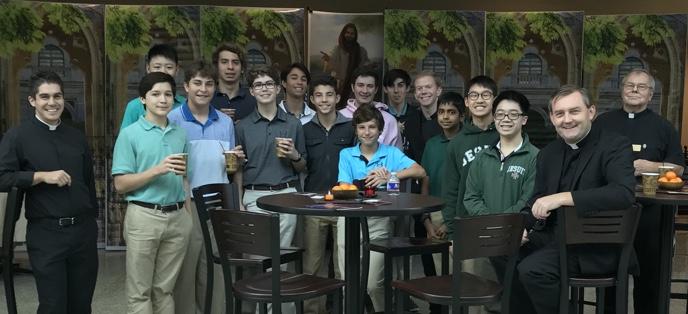 Schools. Pictured are students and priests at Strake Jesuit High School.