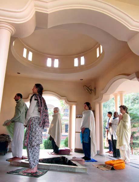 Right: Ashram staff and western visitors standing in the temple at the conclusion of morning meditation.