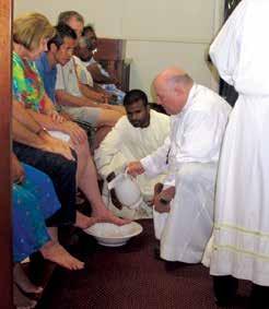 caption Bishop Saunders during the washing of the feet on Holy
