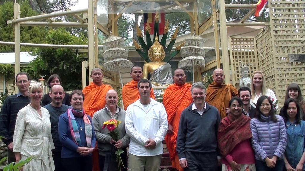 Photo: Members of the Venerable Sangha and Students from our Centre stand in front of the Buddha Rupa