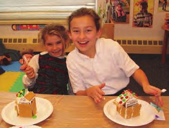 at 7:15 pm A kindergarten and 5 th grade buddy pair work on their gingerbread houses last